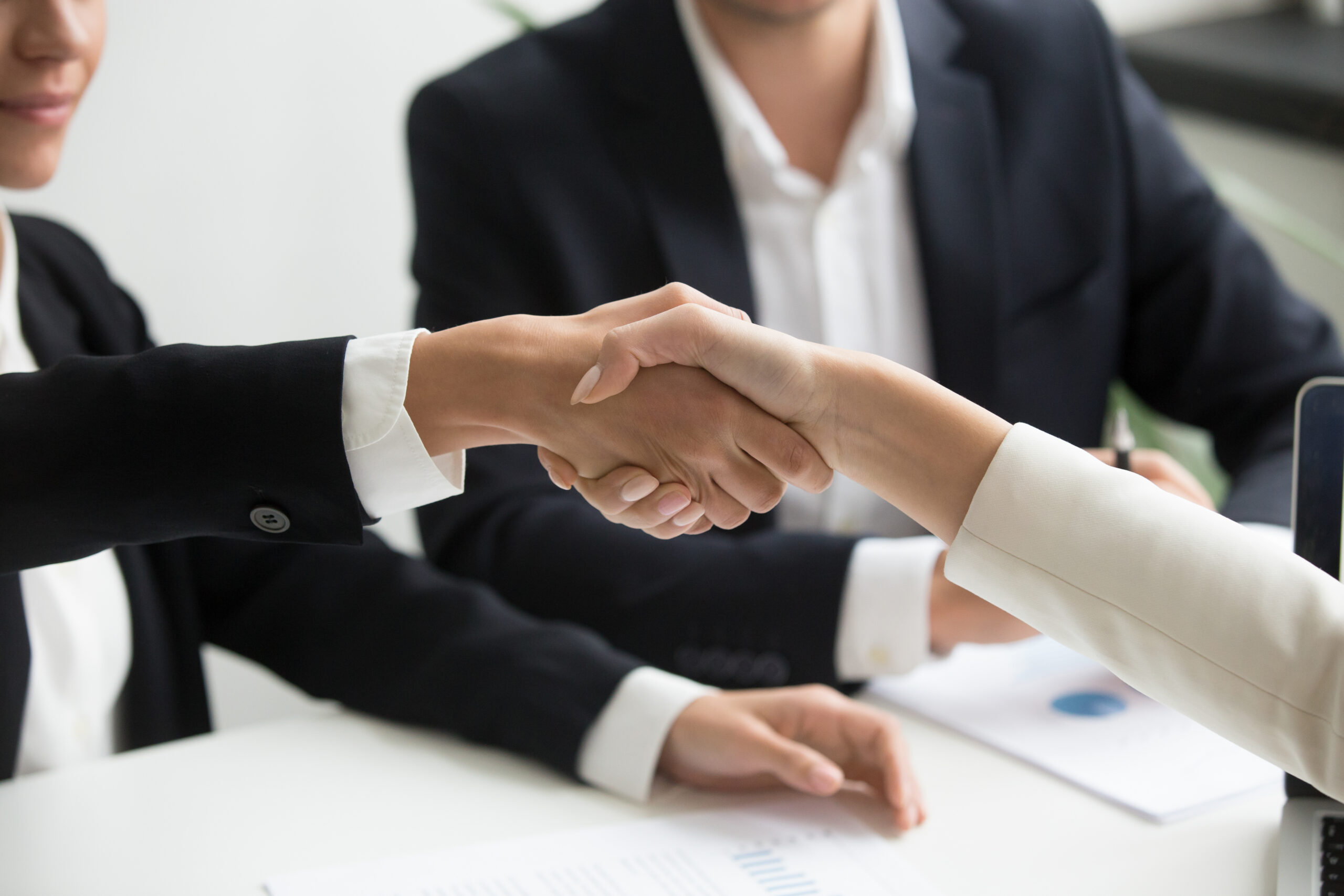 female hands shaking at group meeting making partnership deal, c